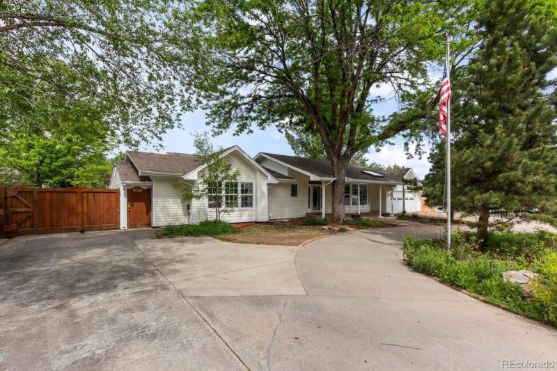Bring your toys! This beautiful and rare ranch-style home sits on a generous .