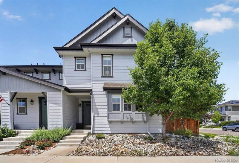 Welcome to 9091 E 59th North Place, a beautifully maintained corner-lot paired home